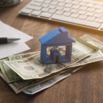 a house on a stack of cash