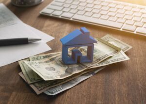 a house on a stack of cash