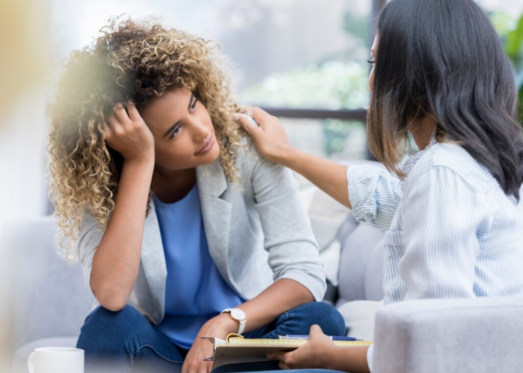 an advisor consoling their client experiencing mental health issues