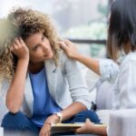 an advisor consoling their client experiencing mental health issues