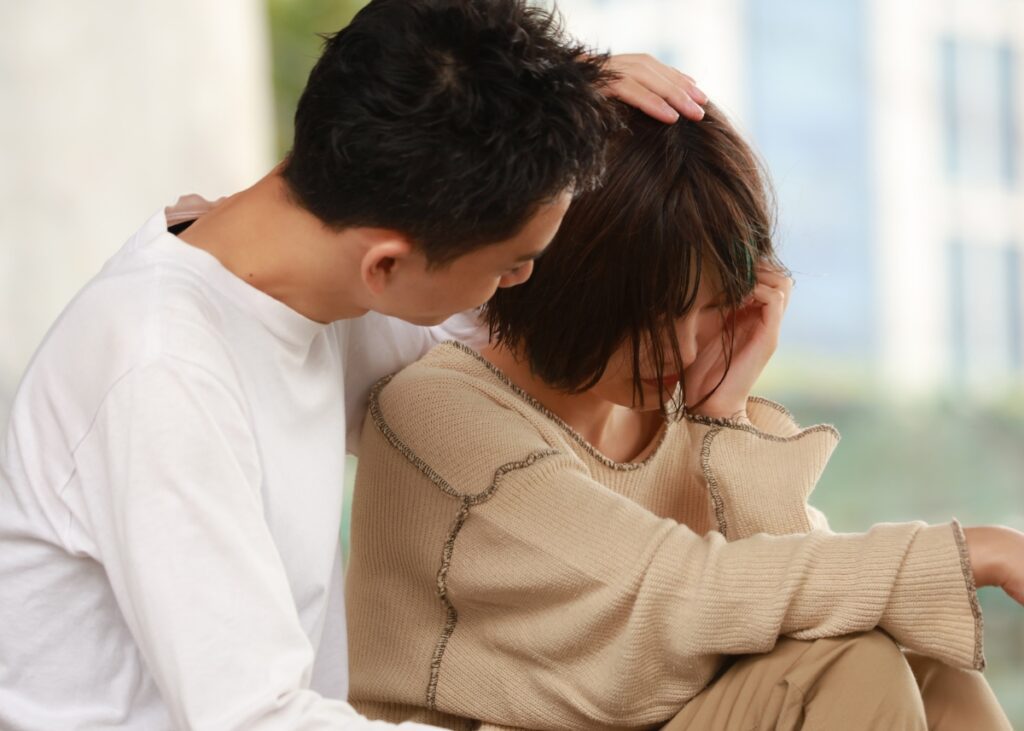 a person consoling a vulnerable family member