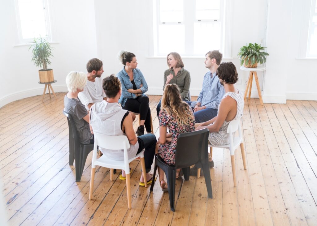 a group of advisors speaking in a circle