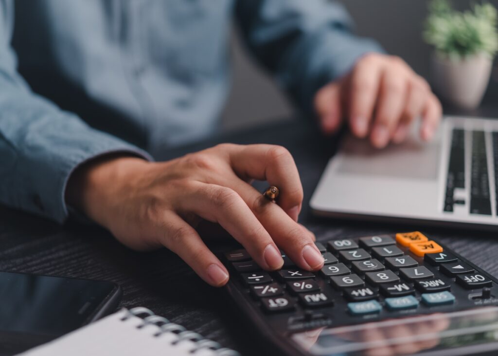 a photo of a man calculating and doing his taxes