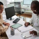 an advisor with his client reviewing the OBBBA within their tax planning and estate planning