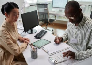 an advisor with his client reviewing the OBBBA within their tax planning and estate planning