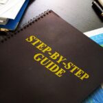 a folder that says step-by-step guide on an advisors desk