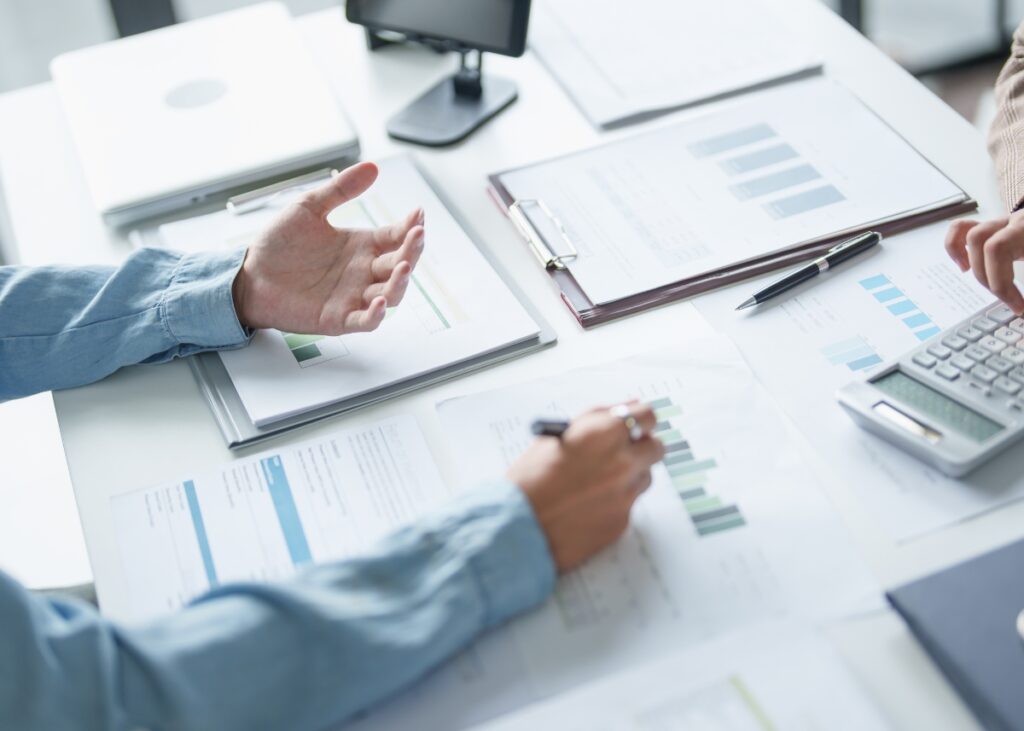 an advisor going over business documents with their client and doing their business well check