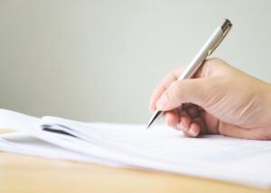 a person writing on their document and fixing the changes being made
