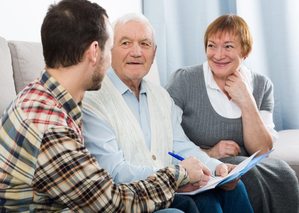 a couple talking to their lawyer checking in on their estate planning and beneficiaries