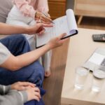 a young adult with his parent and advisor signing legal YAEP documents