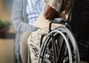a veteran in their wheelchair talking to an advisor