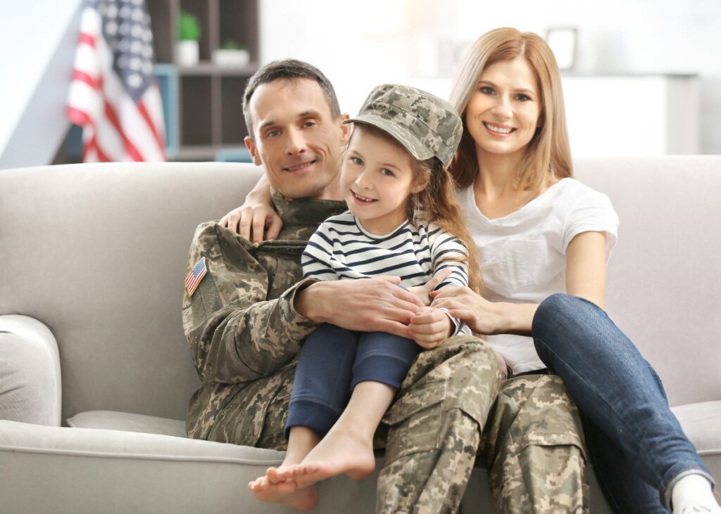 a family sitting with their dad who is a veteran