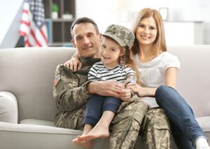 a family sitting with their dad who is a veteran