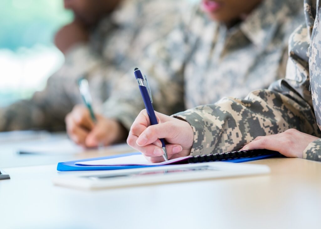 a veteran filling out a piece of paper to qualify for veterans benefits