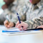 a veteran filling out a piece of paper to qualify for veterans benefits