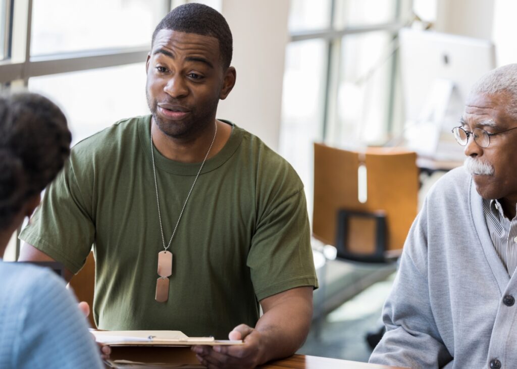 a veteran with his father speaking with an advisor about aid and attendance and other VA benefits