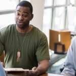 a veteran with his father speaking with an advisor about aid and attendance and other VA benefits