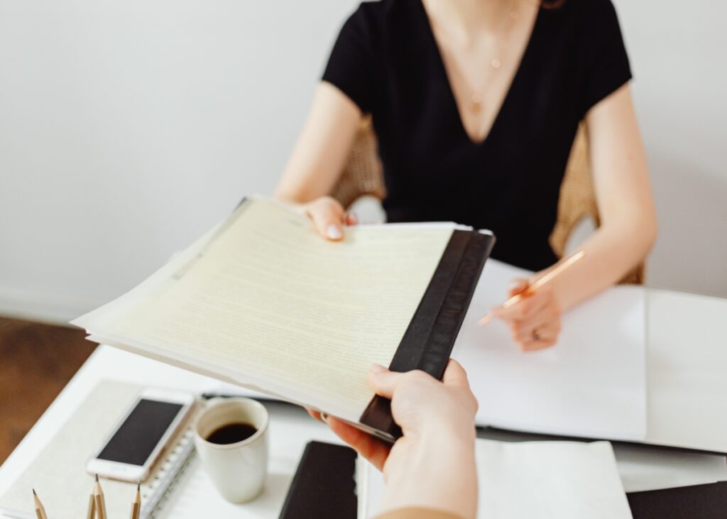 a person handling documents with their advisor.