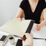 a person handling documents with their advisor.