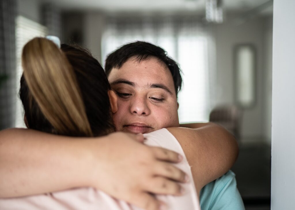 a mom hugging her son with special needs