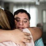 a mom hugging her son with special needs