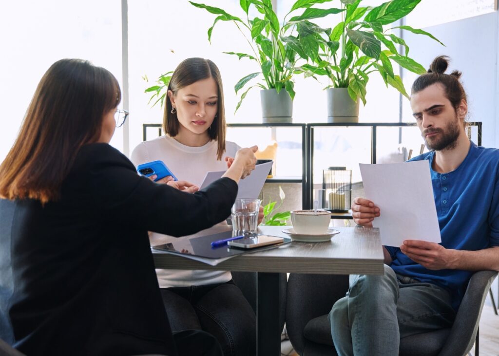 a couple with documents sitting with their estate planning attorney