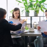 a couple with documents sitting with their estate planning attorney