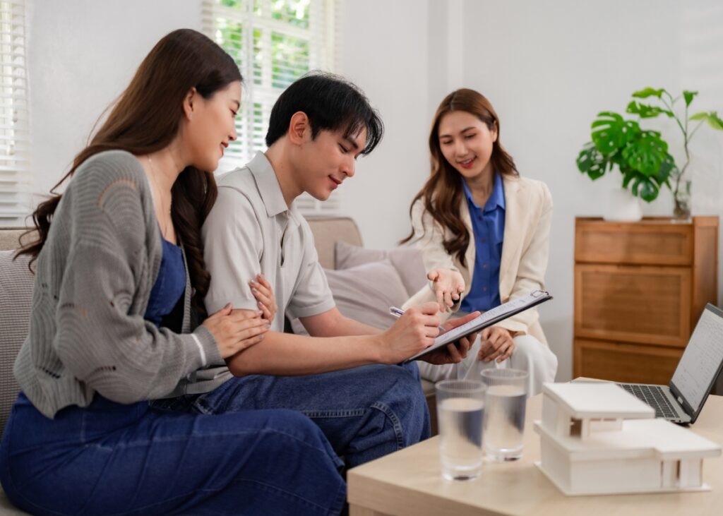 a couple sitting down with an attorney looking over estate planning documents