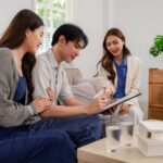 a couple sitting down with an attorney looking over estate planning documents