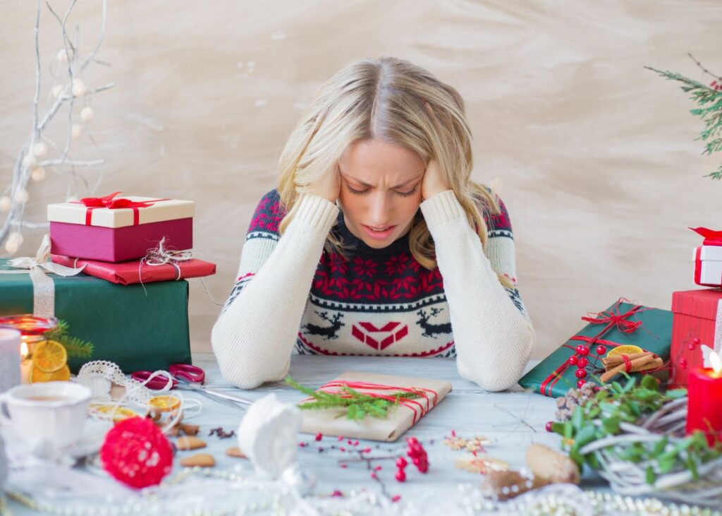 parent looking stressed while wrapping presents.