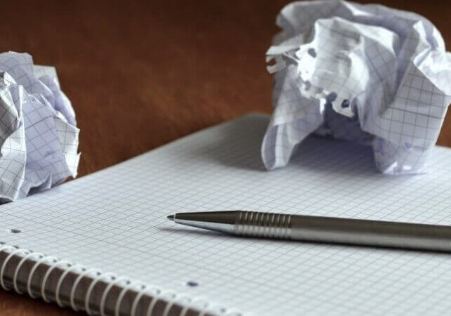 plans notebook with crumbled paper